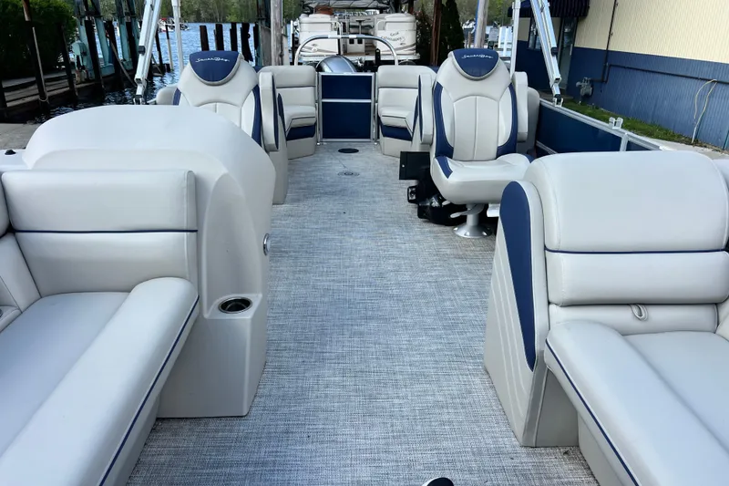 Slide: The Image of 2023 South Bay 224 RS pontoon boat interior with plush seating and modern design. - 18