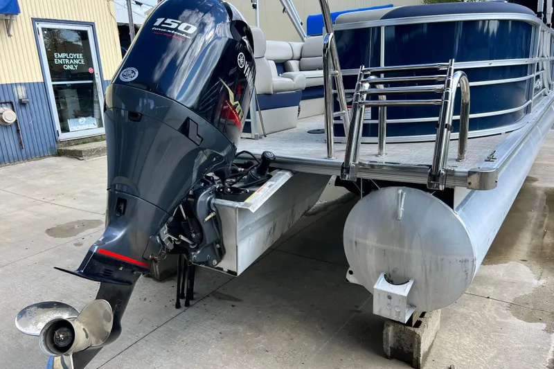 Slide: The Image of 2023 South Bay 224 RS pontoon boat with Yamaha 150 outboard motor, docked on concrete. - 3