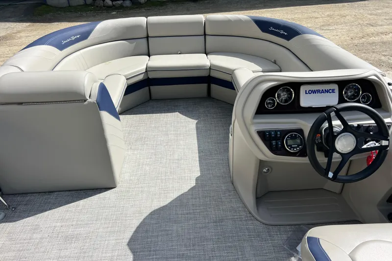 Slide: The Image of 2023 South Bay 224 RS pontoon boat interior with plush seating and modern dashboard. - 9