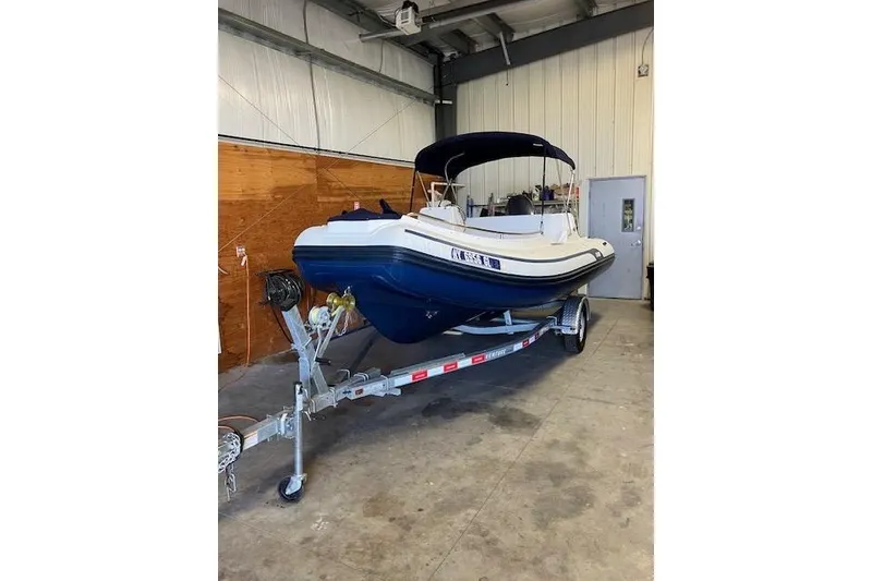 Slide: The Image of 2013 AB Inflatables Nautilus 17 boat on trailer in indoor storage. - 2