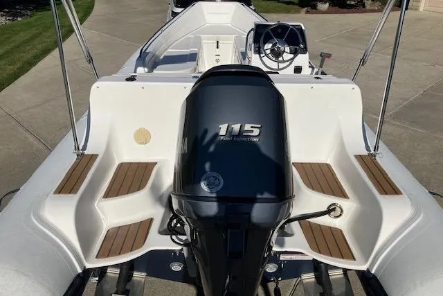 Slide: The Image of 2013 AB Inflatables Nautilus 17 boat with 115 HP engine, featuring sleek design and wood accents. - 7