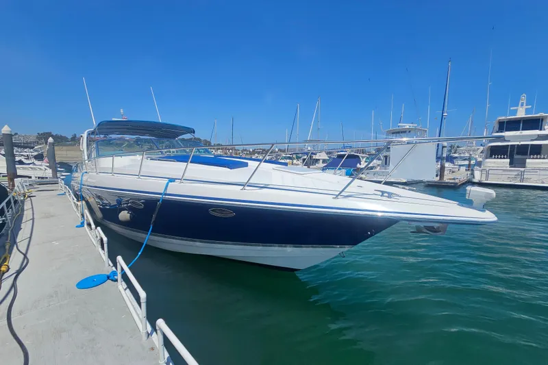 The Image of 2003 Formula 41 Performance Cruiser docked at marina under clear blue sky. - 0