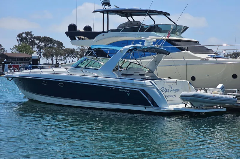 Slide: The Image of 2003 Formula 41 Performance Cruiser yacht docked in marina, featuring sleek design and blue accents. - 1