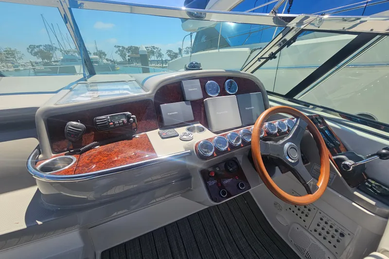 Slide: The Image of Helm of 2003 Formula 41 Performance Cruiser with wood accents and modern controls. - 10