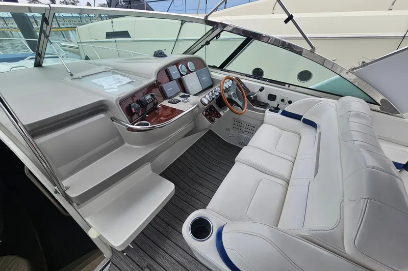 Slide: The Image of 2003 Formula 41 Performance Cruiser cockpit with white seating and modern dashboard controls. - 13
