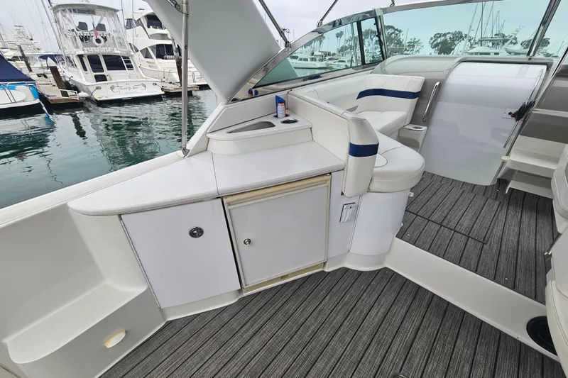 Slide: The Image of 2003 Formula 41 Performance Cruiser interior with seating and storage, docked at marina. - 16