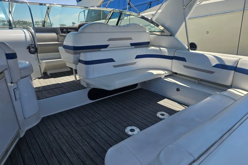 Slide: The Image of 2003 Formula 41 Performance Cruiser interior with white seating and wood flooring. - 17