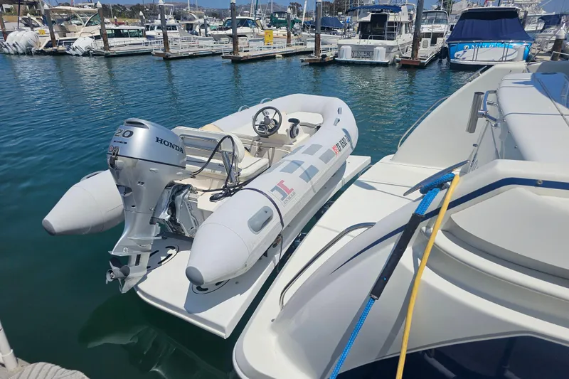 Slide: The Image of 2003 Formula 41 Performance Cruiser with inflatable boat and Honda motor at marina. - 18