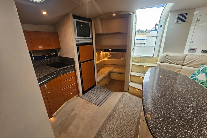 Slide: The Image of Interior of a 2003 Formula 41 Performance Cruiser, featuring a cozy seating area and modern kitchenette. - 20