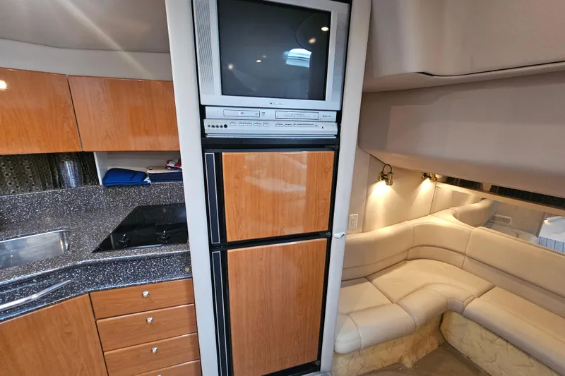 Slide: The Image of Interior of 2003 Formula 41 Performance Cruiser with TV, kitchenette, and seating area. - 23