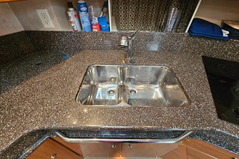 Slide: The Image of Kitchen sink in 2003 Formula 41 Performance Cruiser with granite countertop and faucet. - 25