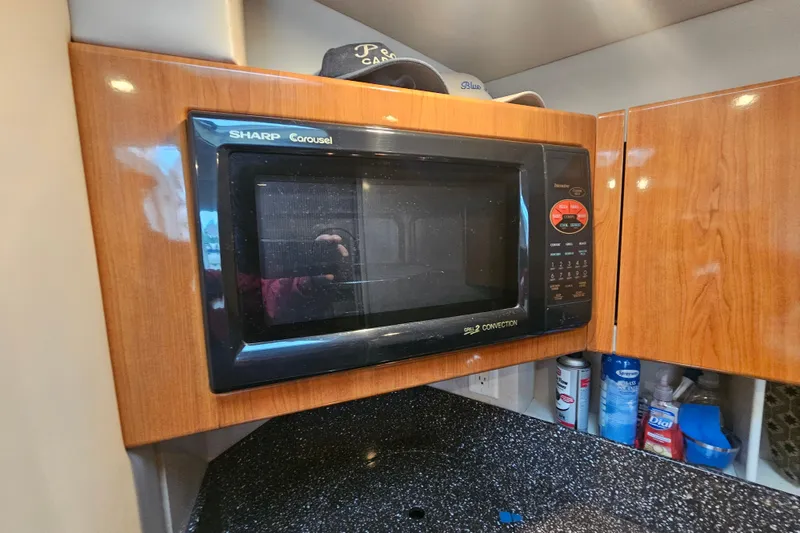 Slide: The Image of Sharp Carousel microwave in a 2003 Formula 41 Performance Cruiser kitchen. - 27