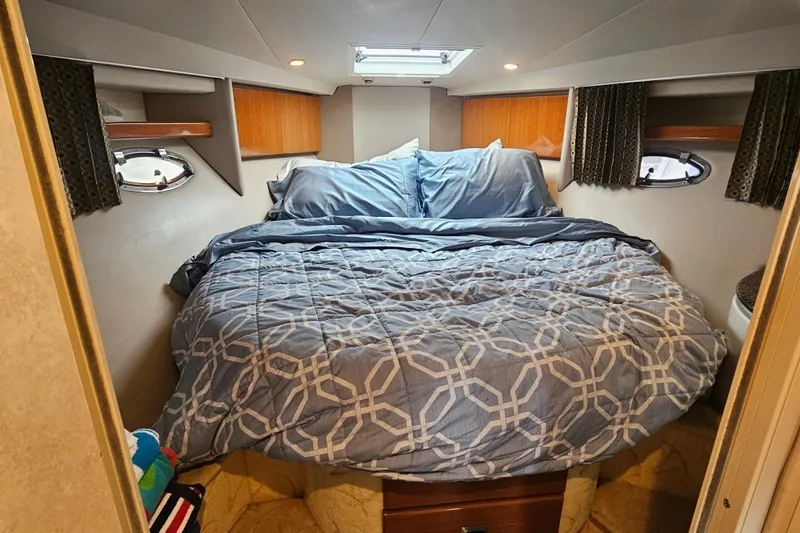Slide: The Image of Cozy bedroom in a 2003 Formula 41 Performance Cruiser yacht with patterned bedding. - 29