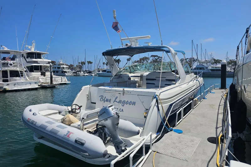 Slide: The Image of 2003 Formula 41 Performance Cruiser docked at marina with inflatable boat attached. - 3