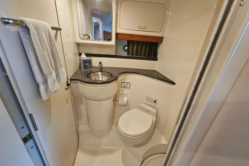 Slide: The Image of Compact bathroom in a 2003 Formula 41 Performance Cruiser, featuring sink and toilet. - 34