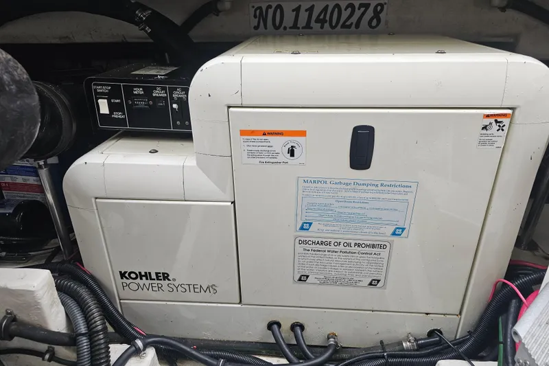 Slide: The Image of Kohler power system in 2003 Formula 41 Performance Cruiser engine room, featuring control panel and safety labels. - 39