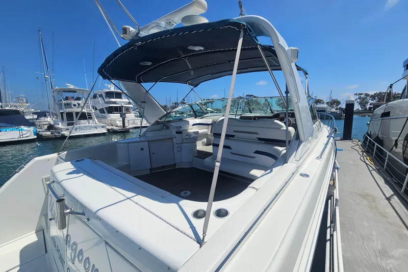 Slide: The Image of 2003 Formula 41 Performance Cruiser docked at marina, showcasing spacious seating and sleek design. - 4
