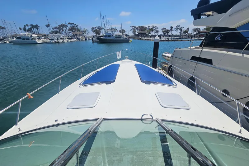 Slide: The Image of 2003 Formula 41 Performance Cruiser docked in a marina, surrounded by other boats. - 6