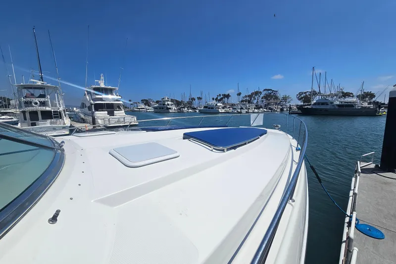 Slide: The Image of 2003 Formula 41 Performance Cruiser docked in a marina under a clear blue sky. - 7