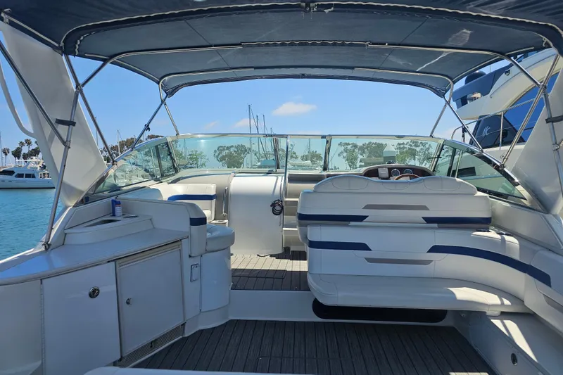 Slide: The Image of 2003 Formula 41 Performance Cruiser interior with seating and helm, docked in marina. - 9