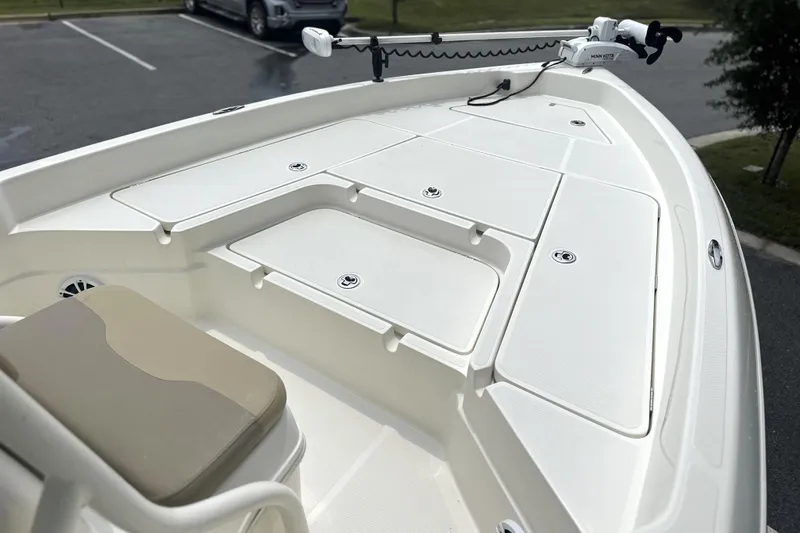 Slide: The Image of 2014 Skeeter SX2250 boat deck with storage compartments and trolling motor. - 10