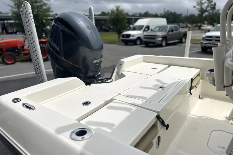 Slide: The Image of 2014 Skeeter SX2250 boat with Yamaha 200 engine, parked outdoors. - 12