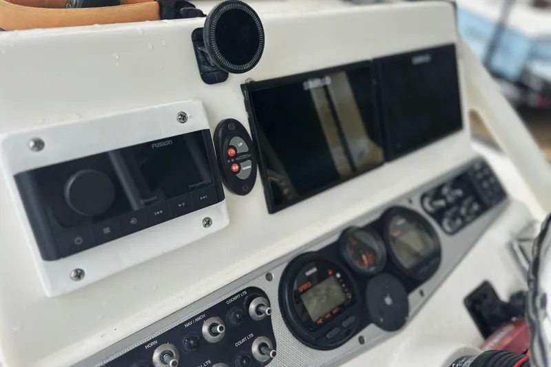 Slide: The Image of Dashboard of a 2014 Skeeter SX2250 boat with navigation and control instruments. - 14