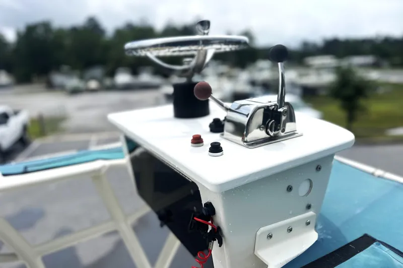 Slide: The Image of 2014 Skeeter SX2250 boat console with steering wheel and controls, outdoor setting. - 16