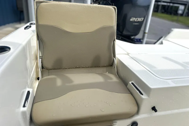 Slide: The Image of 2014 Skeeter SX2250 boat seat with beige upholstery and water droplets. - 17