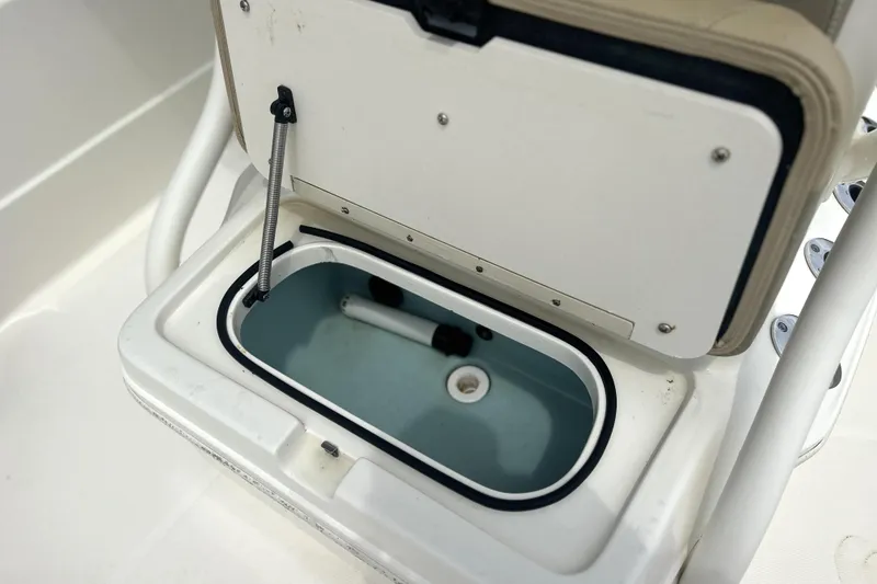 Slide: The Image of Open storage compartment on a 2014 Skeeter SX2250 boat, showcasing interior details. - 18
