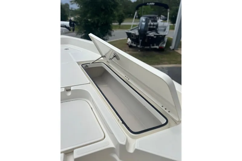 Slide: The Image of Open storage compartment on a 2014 Skeeter SX2250 boat, showcasing interior space. - 21