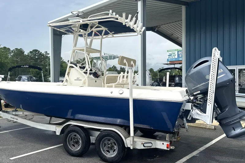 Slide: The Image of 2014 Skeeter SX2250 boat on trailer with Yamaha outboard motor, parked at dealership. - 4