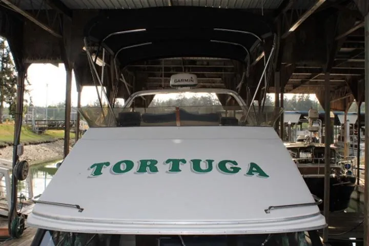 Slide: The Image of 1992 Bayliner 3288 Motoryacht "Tortuga" docked under a covered marina. - 10