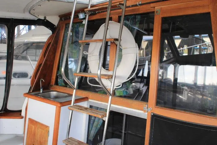 Slide: The Image of 1992 Bayliner 3288 Motoryacht interior with ladder, life preserver, and wooden cabinetry. - 12