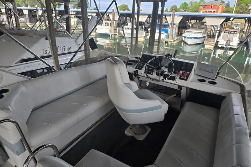 Slide: The Image of Interior view of a 1992 Bayliner 3288 Motoryacht helm with seating and Garmin navigation. - 15