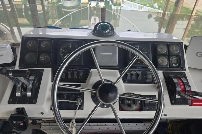 Slide: The Image of Control panel of a 1992 Bayliner 3288 Motoryacht with steering wheel and gauges. - 16