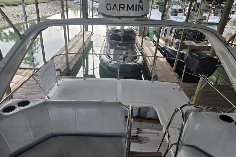 Slide: The Image of Bayliner 3288 Motoryacht 1992 docked, featuring Garmin equipment and spacious seating area. - 17