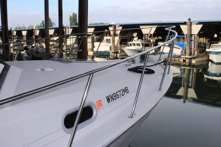 Slide: The Image of 1992 Bayliner 3288 Motoryacht docked in a marina, showcasing sleek design and registration number. - 18