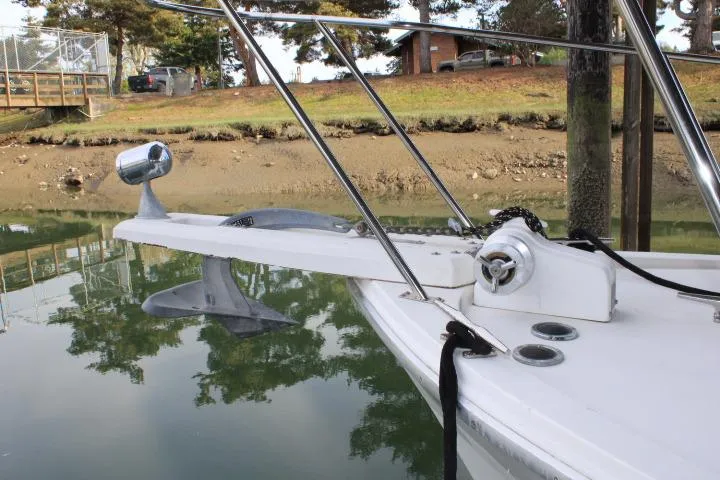 Slide: The Image of 1992 Bayliner 3288 Motoryacht bow with anchor and railing, docked by a calm shoreline. - 19