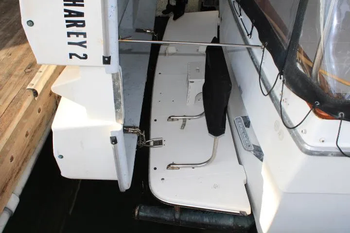 Slide: The Image of 1992 Bayliner 3288 Motoryacht stern view with swim platform and docked setting. - 22