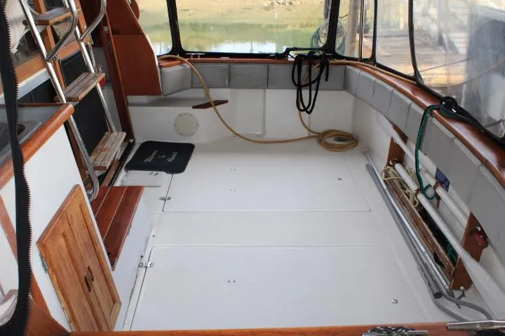 Slide: The Image of 1992 Bayliner 3288 Motoryacht interior with spacious deck, wooden accents, and storage compartments. - 23