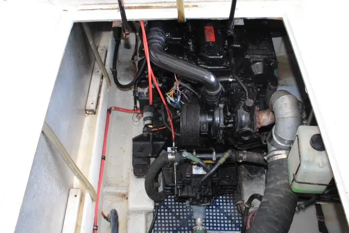 Slide: The Image of Engine compartment of 1992 Bayliner 3288 Motoryacht, showcasing mechanical components and wiring. - 24