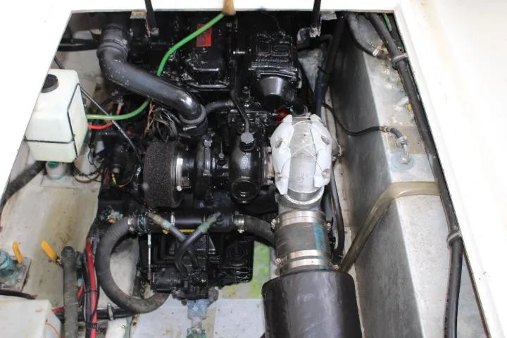 Slide: The Image of Engine compartment of a 1992 Bayliner 3288 Motoryacht, showcasing mechanical components and wiring. - 26