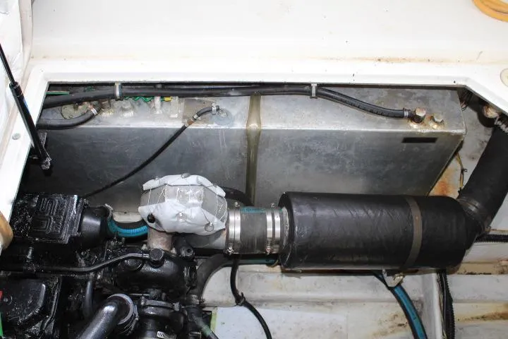 Slide: The Image of Engine compartment of a 1992 Bayliner 3288 Motoryacht, showing mechanical components and piping. - 27