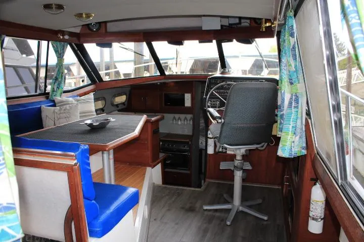 Slide: The Image of Interior of a 1992 Bayliner 3288 Motoryacht with helm, seating, and nautical decor. - 28