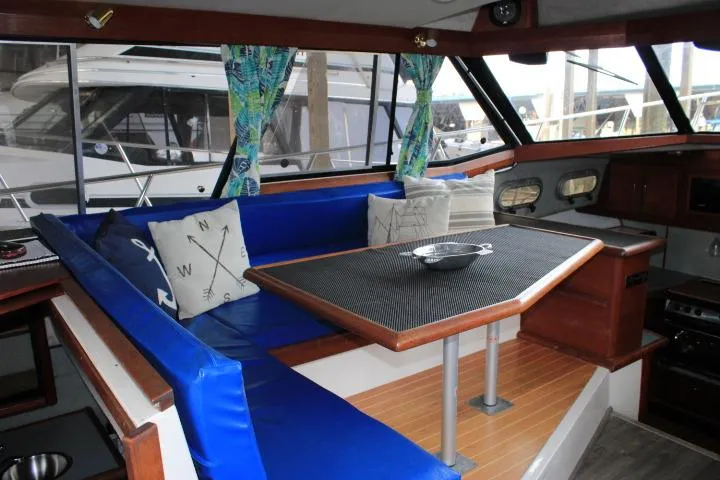 Slide: The Image of Interior of 1992 Bayliner 3288 Motoryacht with blue seating and nautical-themed decor. - 29