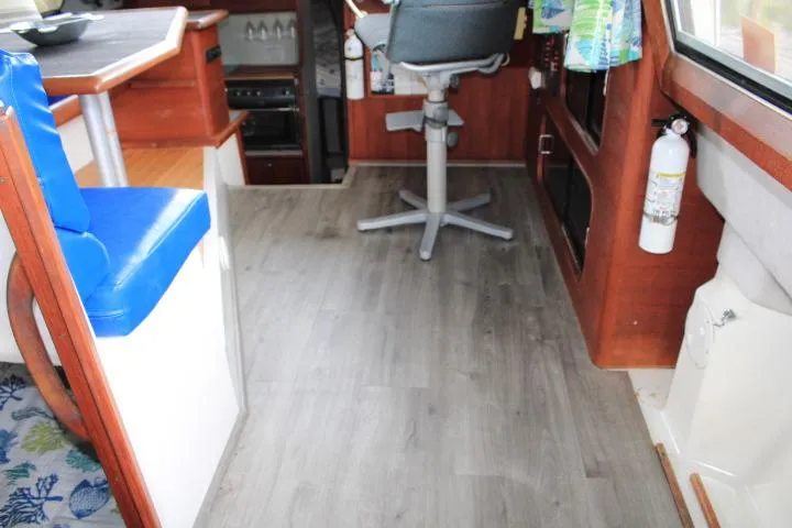 Slide: The Image of Interior of 1992 Bayliner 3288 Motoryacht with wood flooring and blue seating. - 30