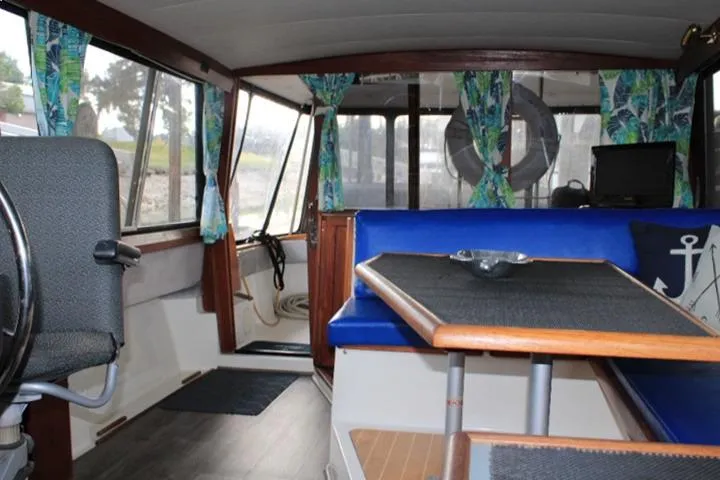 Slide: The Image of Interior of 1992 Bayliner 3288 Motoryacht with blue seating and nautical decor. - 34