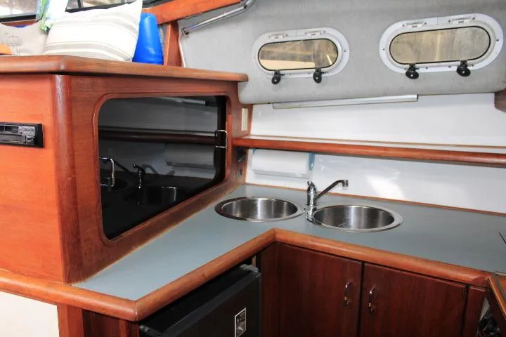 Slide: The Image of Interior of 1992 Bayliner 3288 Motoryacht kitchen with dual sinks and wooden cabinetry. - 35