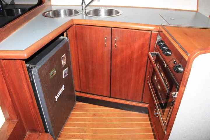 Slide: The Image of 1992 Bayliner 3288 Motoryacht kitchen with wood cabinets, dual sinks, fridge, and stove. - 39